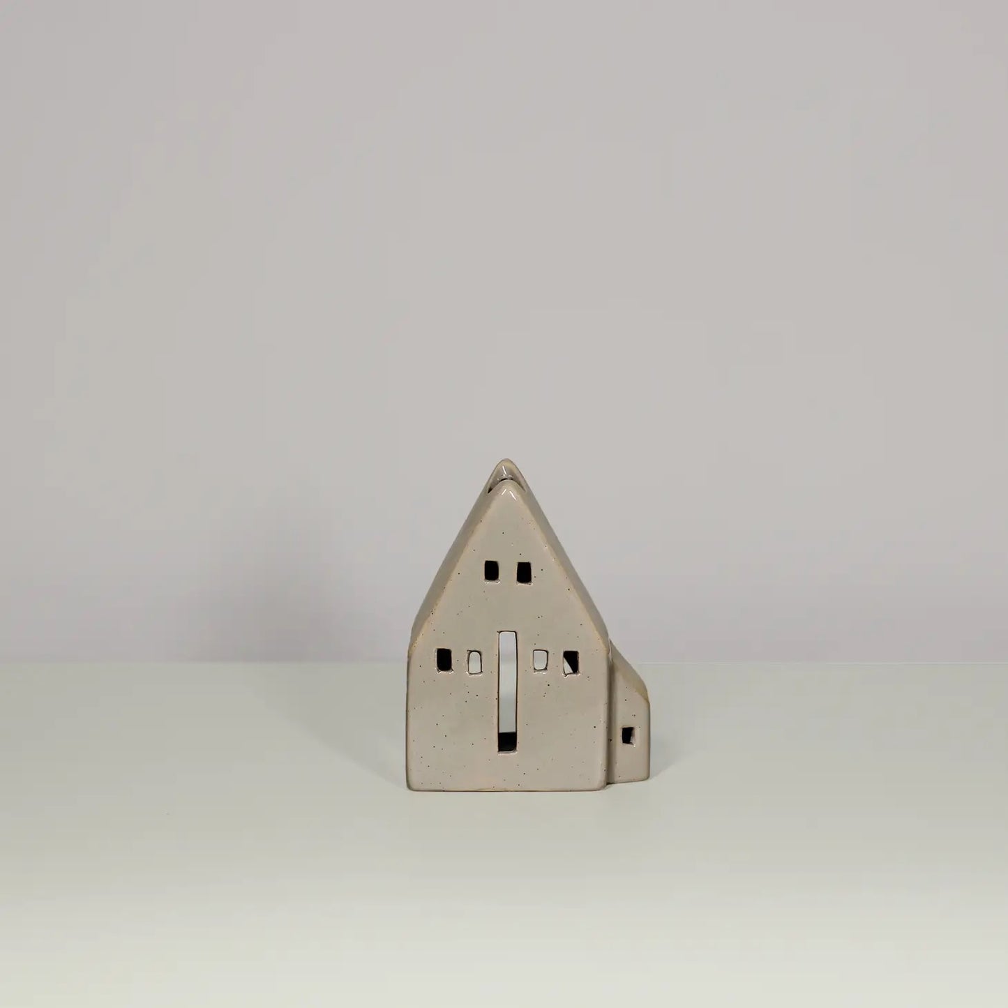 Glazed beige ceramic tea light house