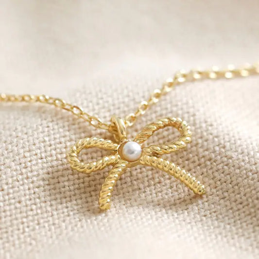 Tiny Pearl Bow Necklace in Gold