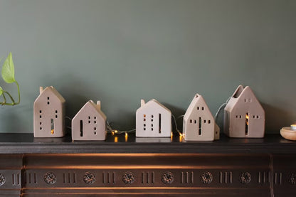 Glazed beige ceramic tea light house